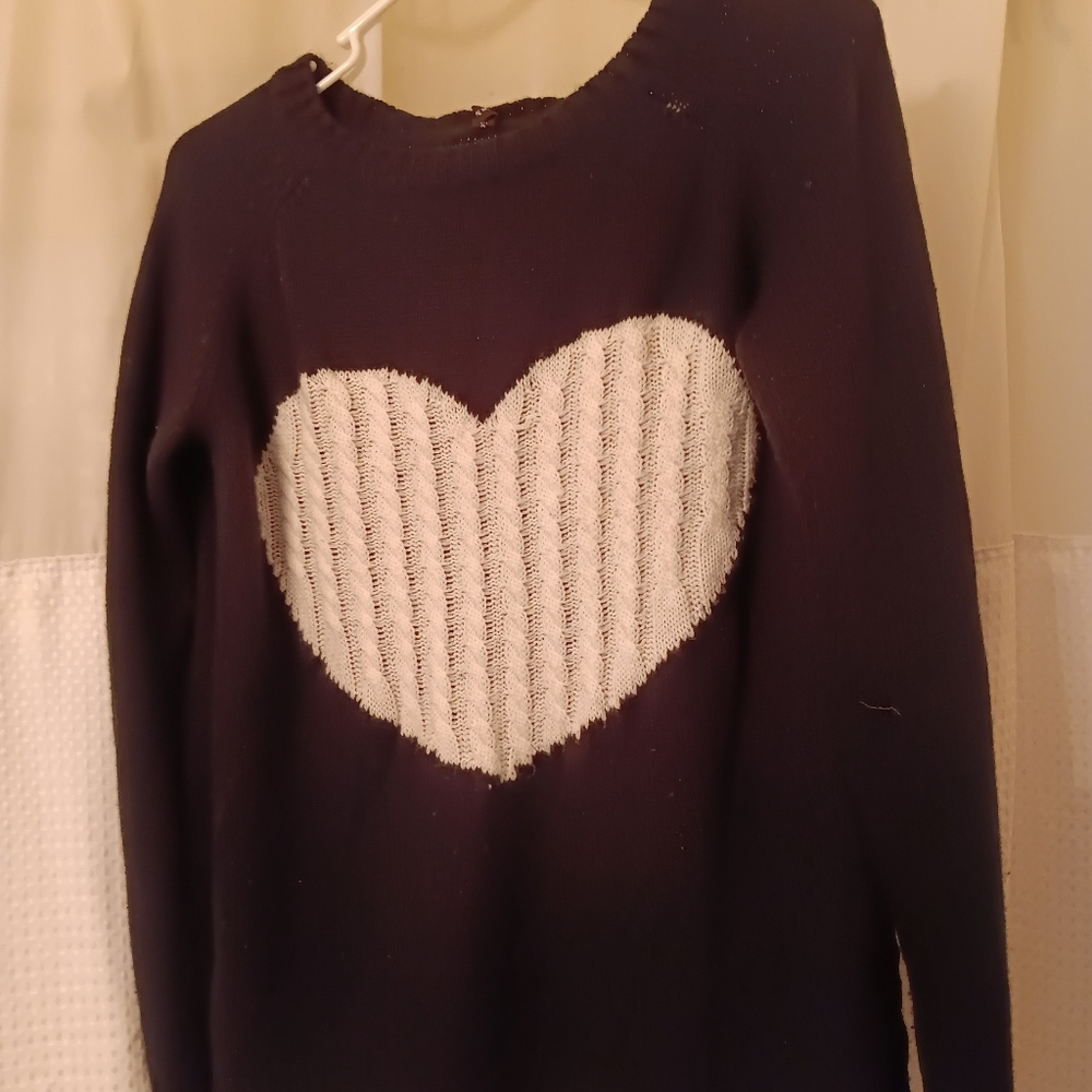 Black acrylic sweater with white heart on chest